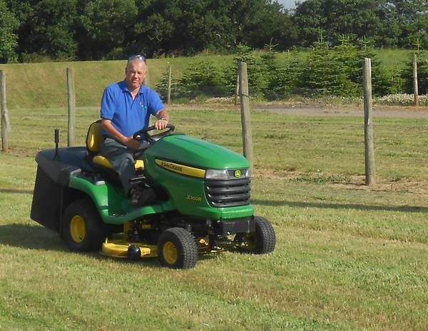 Nigel mowing lawn with ride on mower